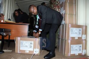 KNEC Official opening a national examination container 