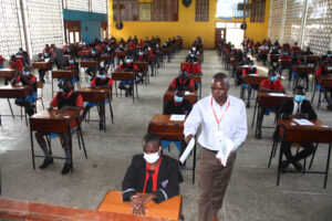 Teacher distributing KCSE national exams 